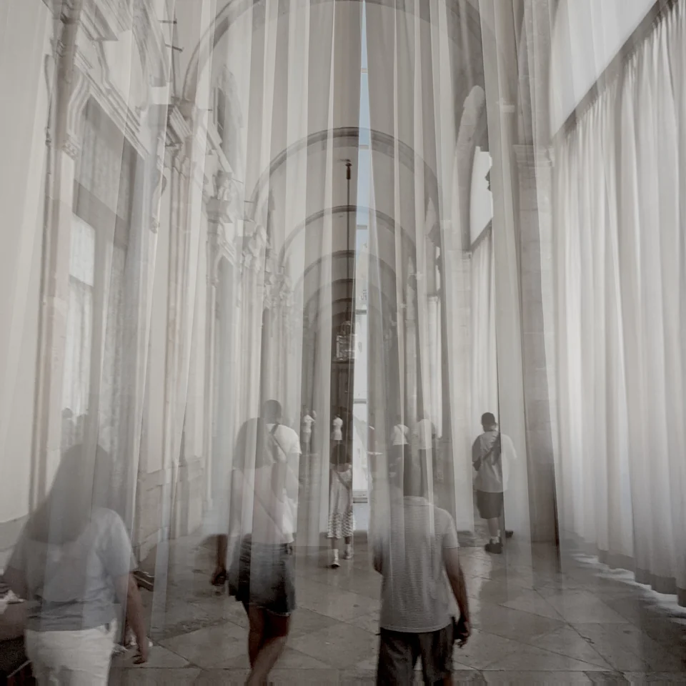 A cathedral interior layered with tall columns in black and white.