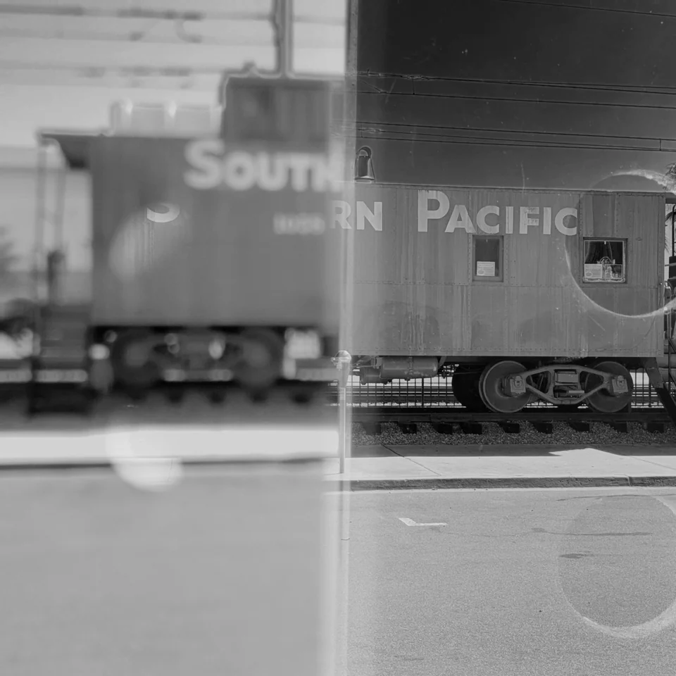 A Southern Pacific train in a black-and-white double exposure.