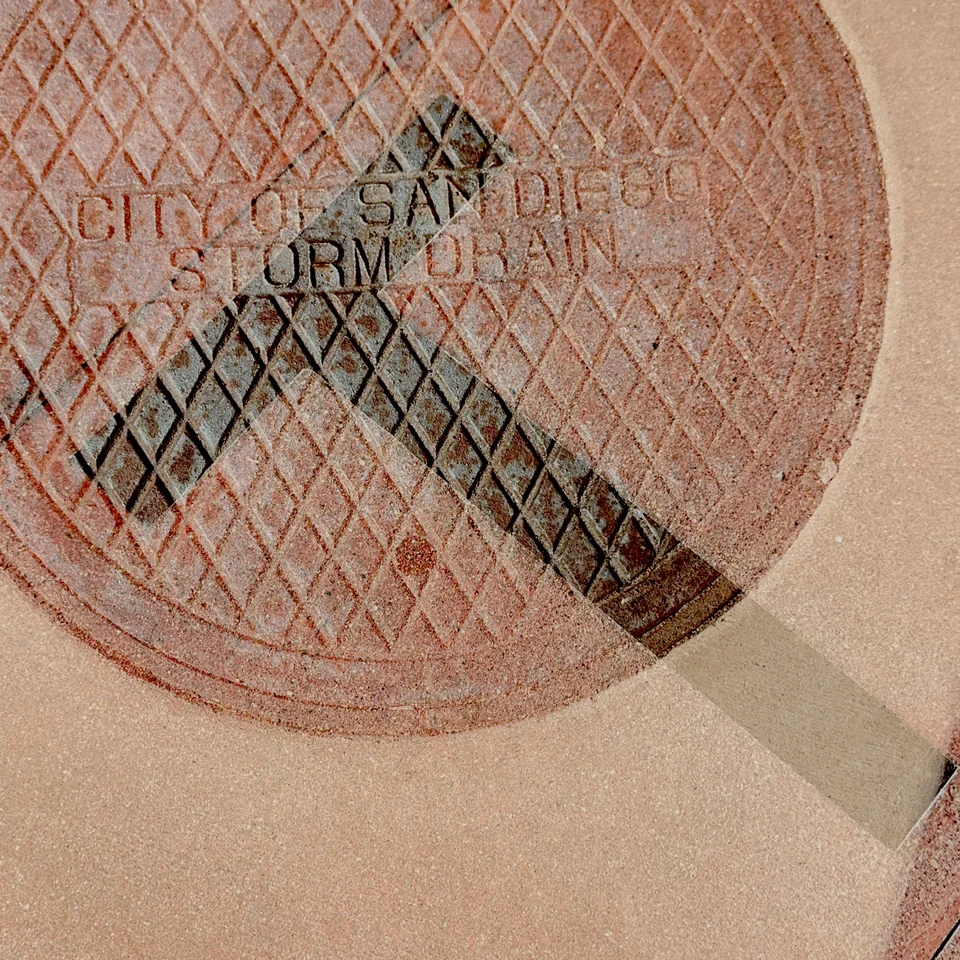 A tennis racket layered with lettering and warm textured surfaces.